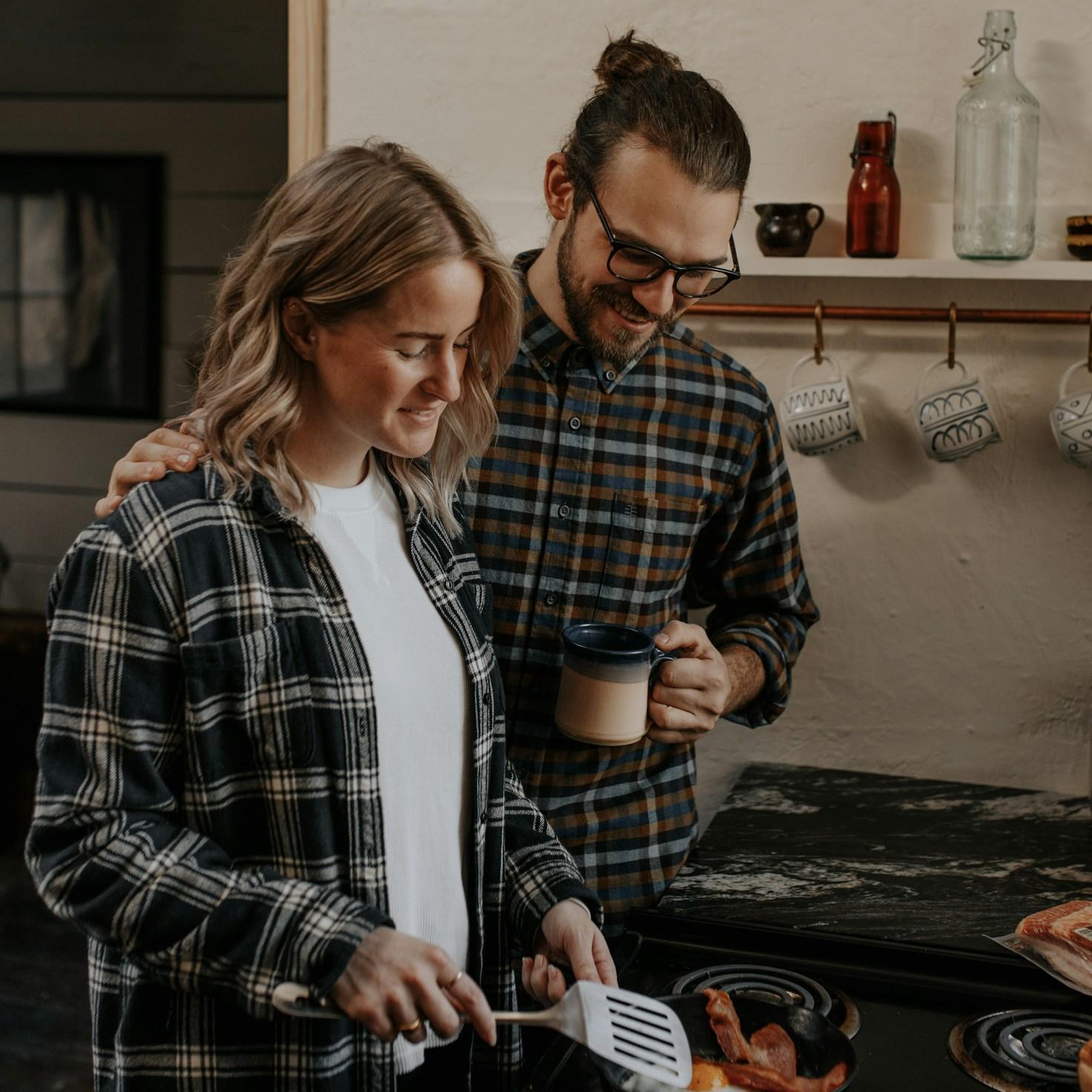 Community members collaborating in a contemporary kitchen, exchanging recipes and cooking techniques